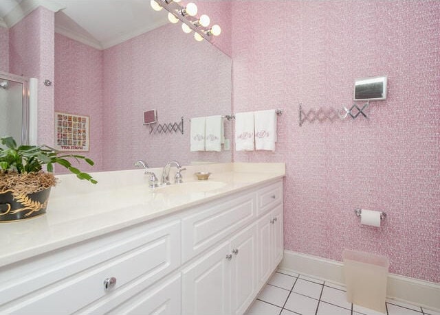 bathroom featuring tile patterned flooring, vanity, and a shower with door