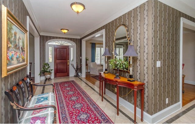 entrance foyer featuring crown molding