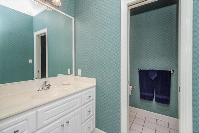 bathroom featuring tile patterned floors, vanity, and ornamental molding