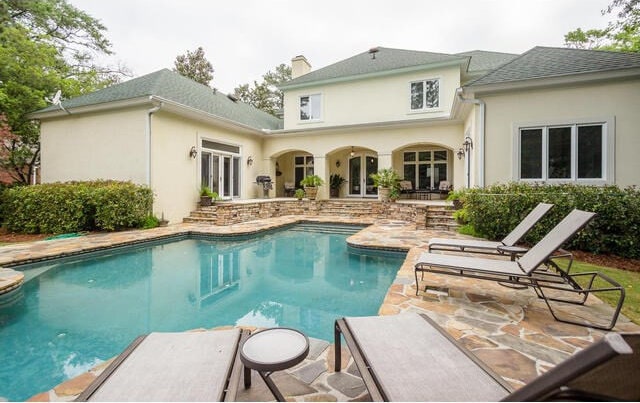 view of pool featuring a patio area and french doors