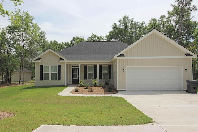 view of front of property featuring an attached garage, a front yard, concrete driveway, and roof with shingles