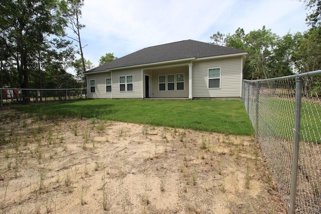 rear view of house featuring a shingled roof