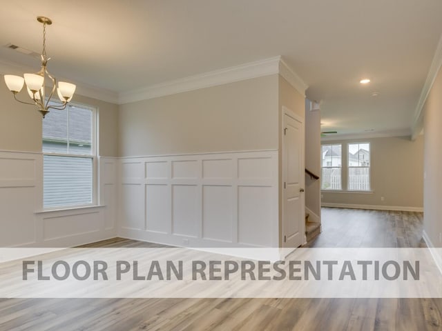 unfurnished dining area with wood-type flooring, a chandelier, and crown molding