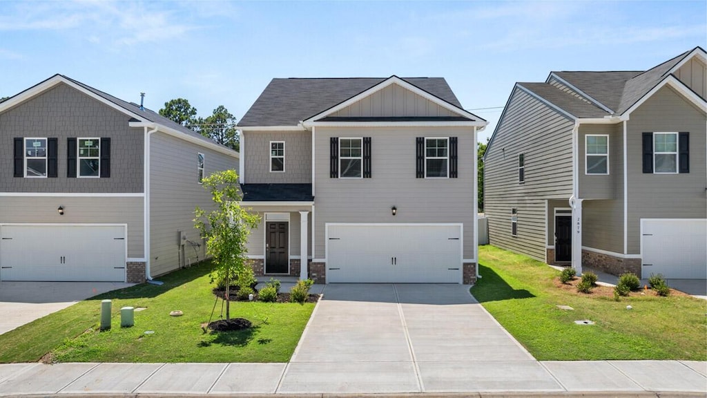 view of front of house featuring a garage and a front yard