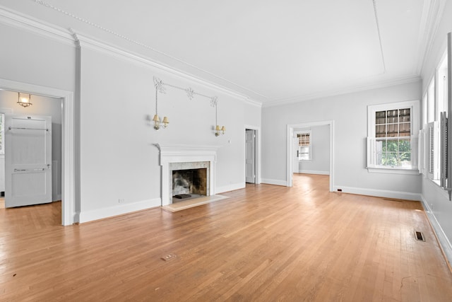 unfurnished living room with light hardwood / wood-style floors and crown molding