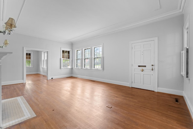 unfurnished living room featuring crown molding and light wood-type flooring