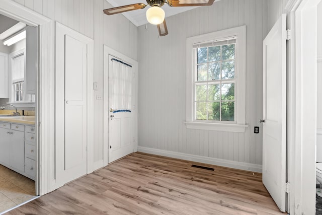 unfurnished bedroom featuring light hardwood / wood-style floors, ceiling fan, and sink