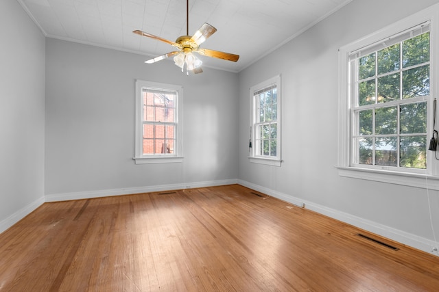 unfurnished room with hardwood / wood-style floors, ceiling fan, and crown molding