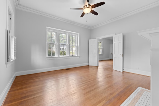 empty room featuring light hardwood / wood-style floors, ceiling fan, and crown molding