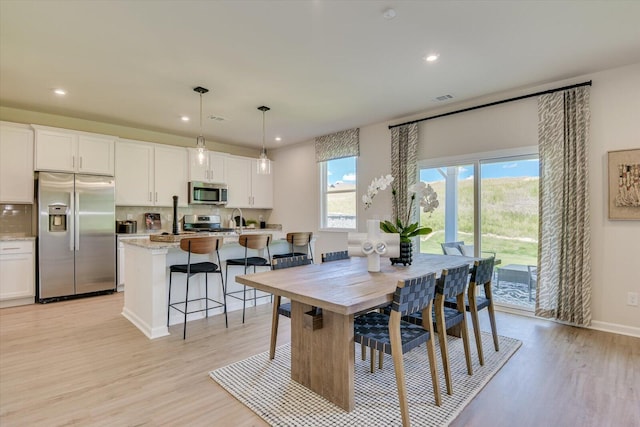 dining area with light hardwood / wood-style flooring