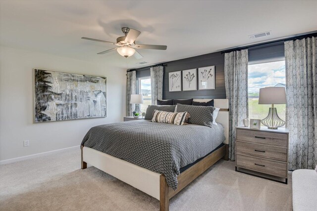 bedroom featuring light carpet and ceiling fan