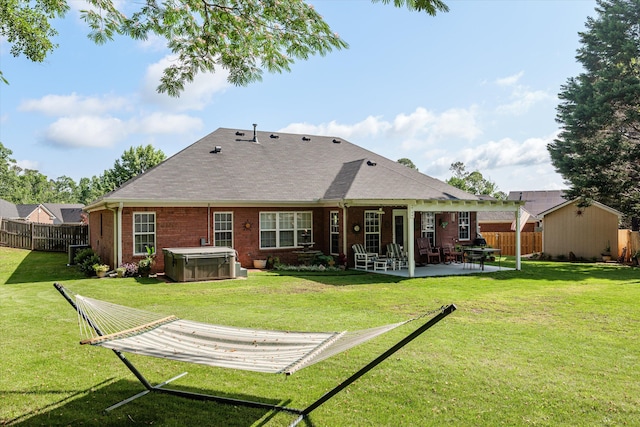 721 Spalding Ct, Martinez, GA 30907 - rear view of property with a hot tub, a patio, brick siding, and a shingled roof