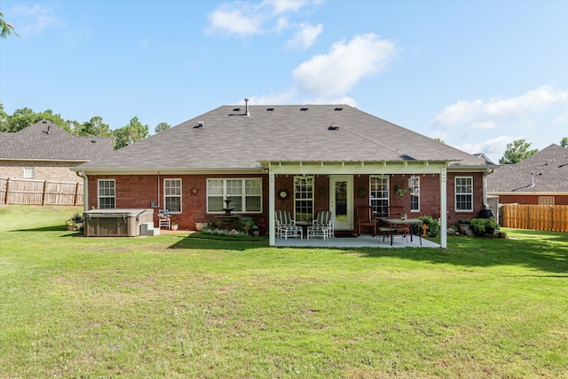 721 Spalding Ct, Martinez, GA 30907 - back of property with a hot tub, a patio, brick siding, and roof with shingles