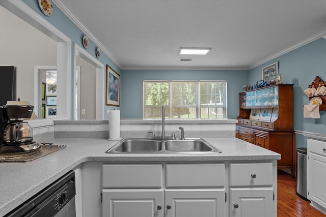721 Spalding Ct, Martinez, GA 30907 - kitchen featuring a sink, dishwasher, ornamental molding, wood finished floors, and white cabinetry