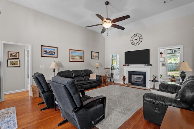 721 Spalding Ct, Martinez, GA 30907 - living room with high vaulted ceiling, light wood-style floors, a ceiling fan, baseboards, and a fireplace with flush hearth