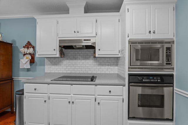 721 Spalding Ct, Martinez, GA 30907 - kitchen with appliances with stainless steel finishes, under cabinet range hood, light countertops, crown molding, and white cabinets