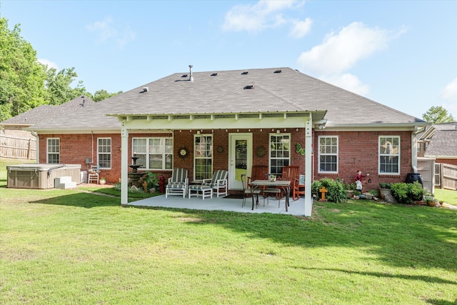 721 Spalding Ct, Martinez, GA 30907 - back of property featuring a hot tub, a patio area, brick siding, and a shingled roof