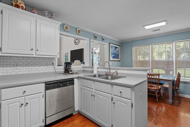 721 Spalding Ct, Martinez, GA 30907 - kitchen with stainless steel dishwasher, a sink, a peninsula, crown molding, and light countertops