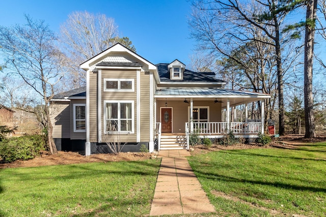 view of front of house with ceiling fan, a porch, and a front yard