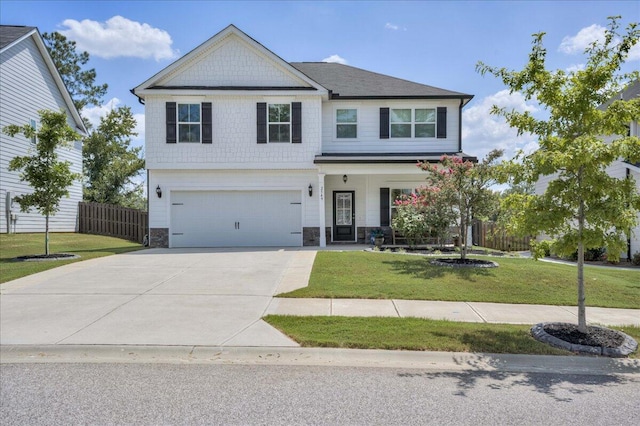 view of front of home featuring a front yard and a garage