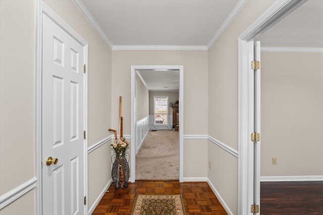 hall with dark parquet floors and crown molding