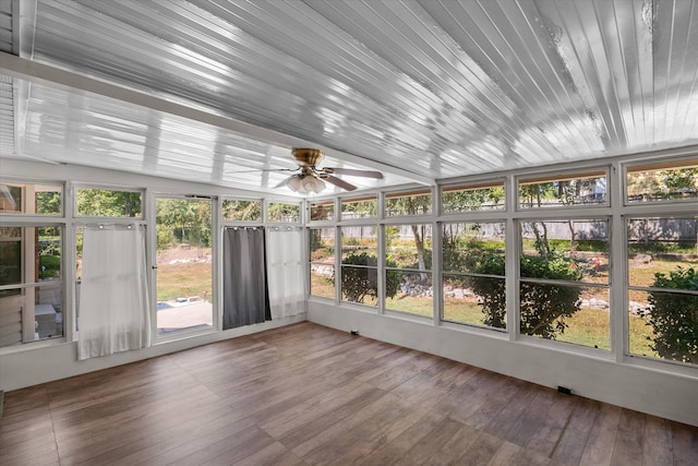 unfurnished sunroom featuring ceiling fan