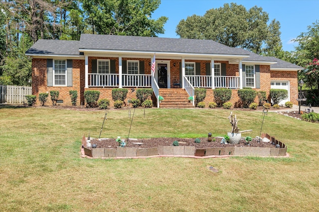 ranch-style home featuring a porch, a garage, and a front lawn