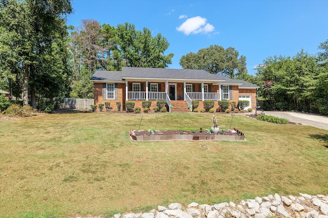 ranch-style house with a porch, a garage, and a front yard