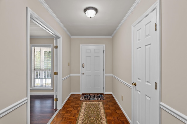 doorway to outside with dark parquet flooring and ornamental molding