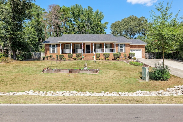 single story home with a porch, a garage, and a front lawn