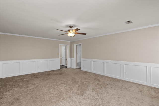 empty room with light colored carpet, ceiling fan, and crown molding