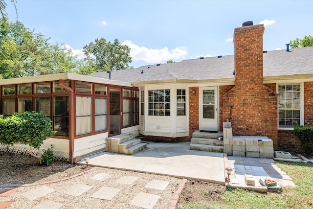 back of property featuring a patio and a sunroom