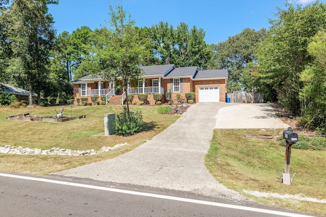 ranch-style house featuring a front yard, a porch, and a garage