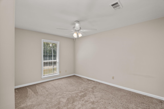 carpeted spare room featuring ceiling fan