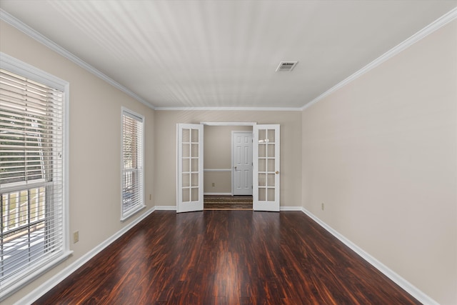 spare room featuring french doors, dark hardwood / wood-style flooring, a wealth of natural light, and crown molding