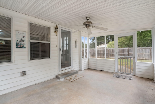 unfurnished sunroom featuring ceiling fan