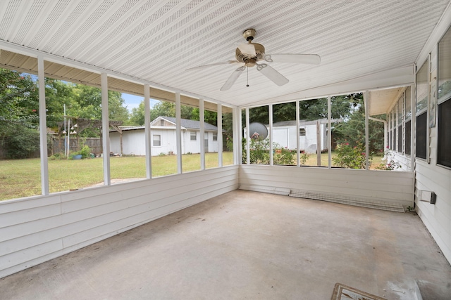 unfurnished sunroom with ceiling fan