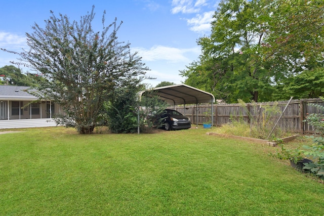 view of yard with a carport and a sunroom