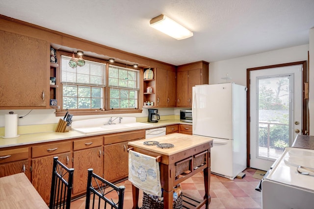 1730 Kissingbower Rd, Augusta, GA 30904 - kitchen with white appliances, open shelves, brown cabinets, and light countertops