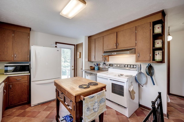 1730 Kissingbower Rd, Augusta, GA 30904 - kitchen with white appliances, under cabinet range hood, light countertops, brown cabinetry, and a textured ceiling