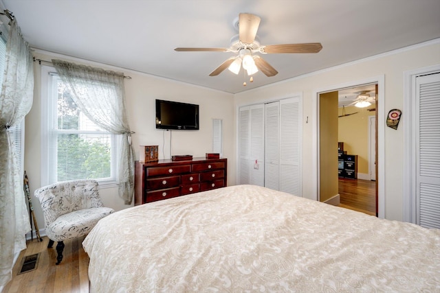 1730 Kissingbower Rd, Augusta, GA 30904 - bedroom with wood finished floors, multiple closets, crown molding, and a ceiling fan