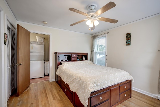 1730 Kissingbower Rd, Augusta, GA 30904 - bedroom featuring estacked washer and dryer, light wood-style flooring, crown molding, ceiling fan, and a closet