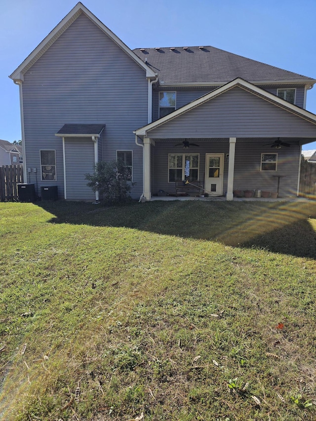 rear view of house with a patio, a lawn, fence, and a ceiling fan