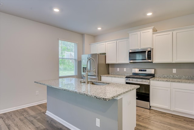 6093 Whitewater Dr, North Augusta, SC 29841 - kitchen featuring stainless steel appliances, white cabinets, an island with sink, light wood-type flooring, and recessed lighting