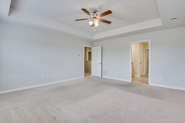 6093 Whitewater Dr, North Augusta, SC 29841 - unfurnished bedroom featuring a raised ceiling, light carpet, ensuite bath, and ceiling fan