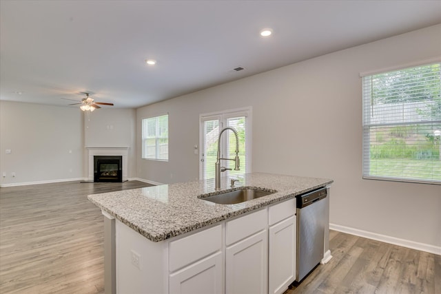 6093 Whitewater Dr, North Augusta, SC 29841 - kitchen with stainless steel dishwasher, ceiling fan, a kitchen island with sink, light wood-style floors, and white cabinets