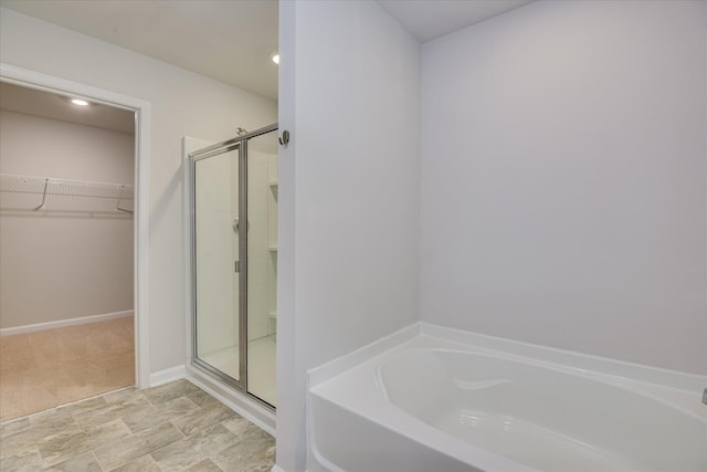 6093 Whitewater Dr, North Augusta, SC 29841 - bathroom with a garden tub, a shower stall, and a spacious closet