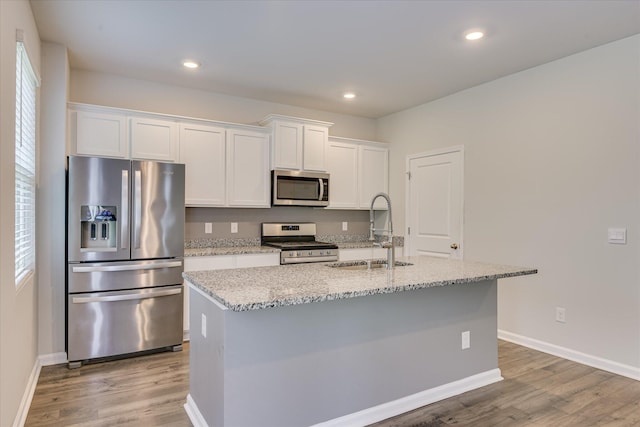 6093 Whitewater Dr, North Augusta, SC 29841 - kitchen featuring stainless steel appliances, light wood-style floors, white cabinetry, a center island with sink, and recessed lighting