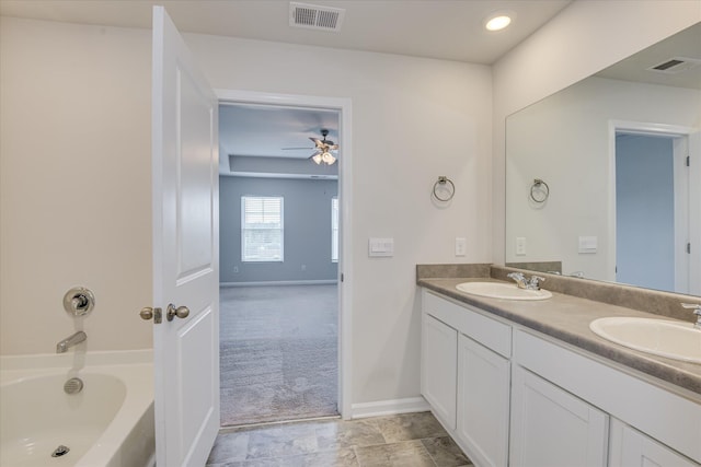 6093 Whitewater Dr, North Augusta, SC 29841 - full bath with double vanity, a tub to relax in, and a ceiling fan