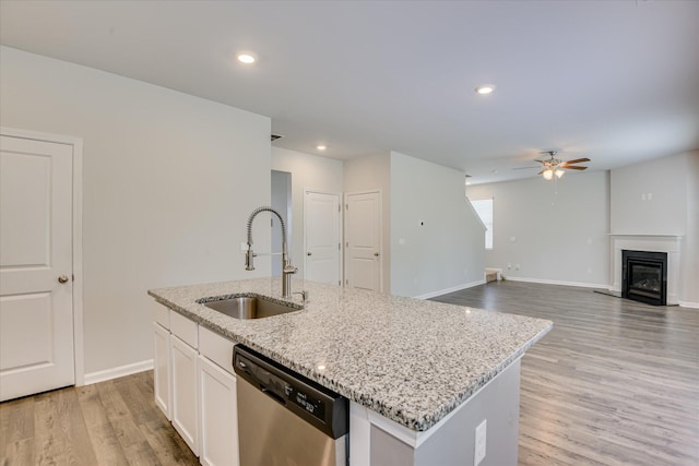 6093 Whitewater Dr, North Augusta, SC 29841 - kitchen with stainless steel dishwasher, a ceiling fan, light wood-style floors, light stone countertops, and a center island with sink